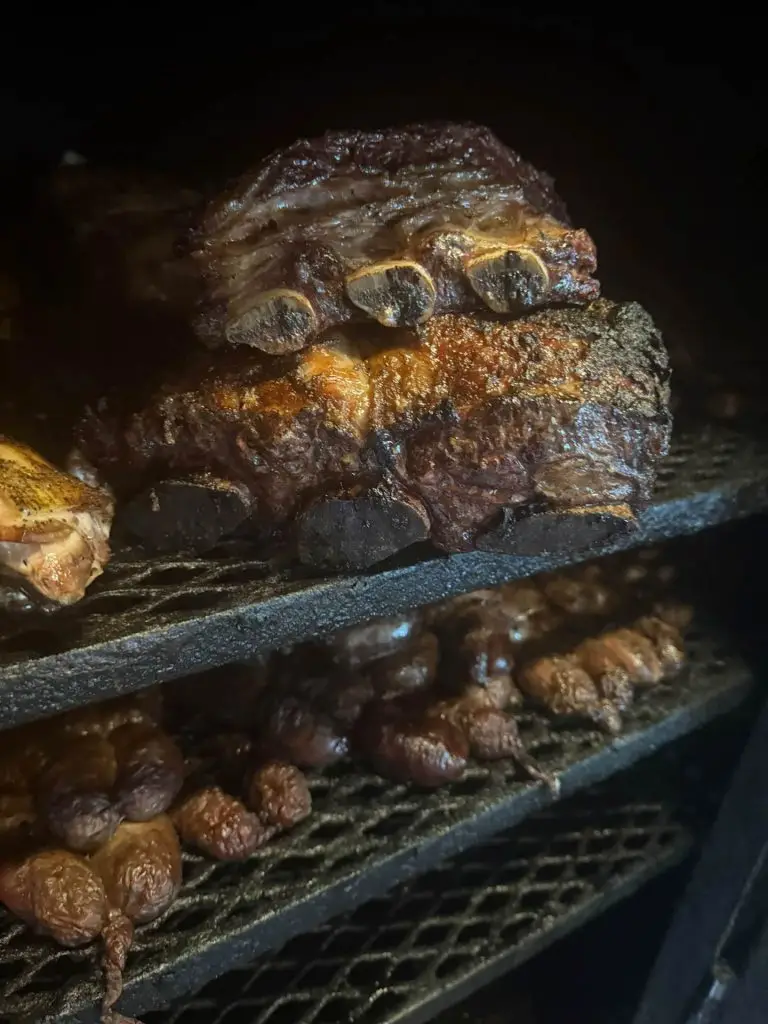Ribs and brisket on the smoker grates