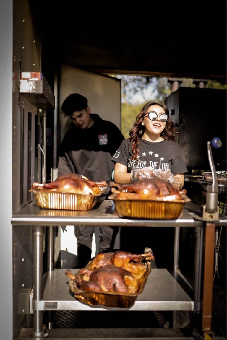 The crew serving smoked turkeys from the food truck window