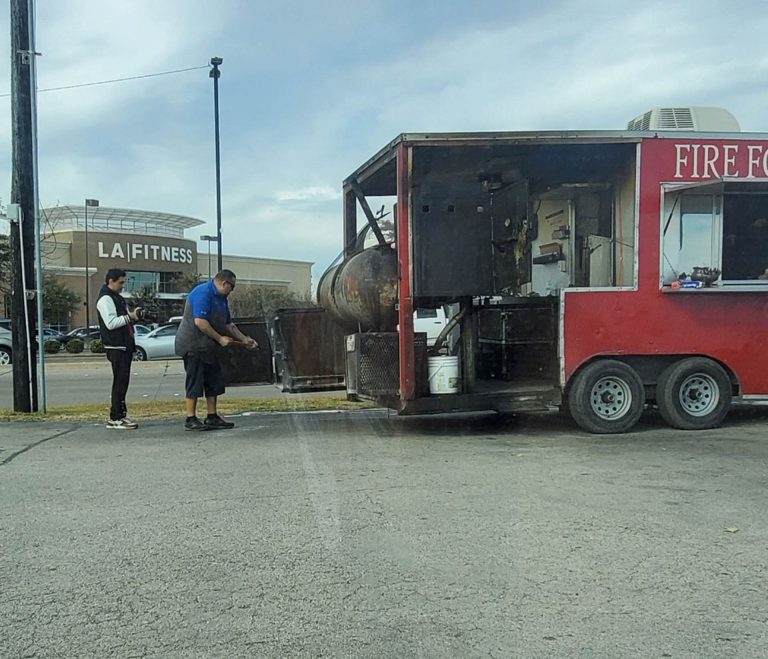 The Fire for the Lord BBQ food truck serving customers in a parking lot